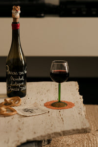 Annabelle wine glass by Olsson & Jensen with red wine on a stone table