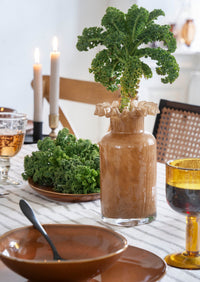 cut glass wine glasses styled on a relaxed dining table with ceramics
