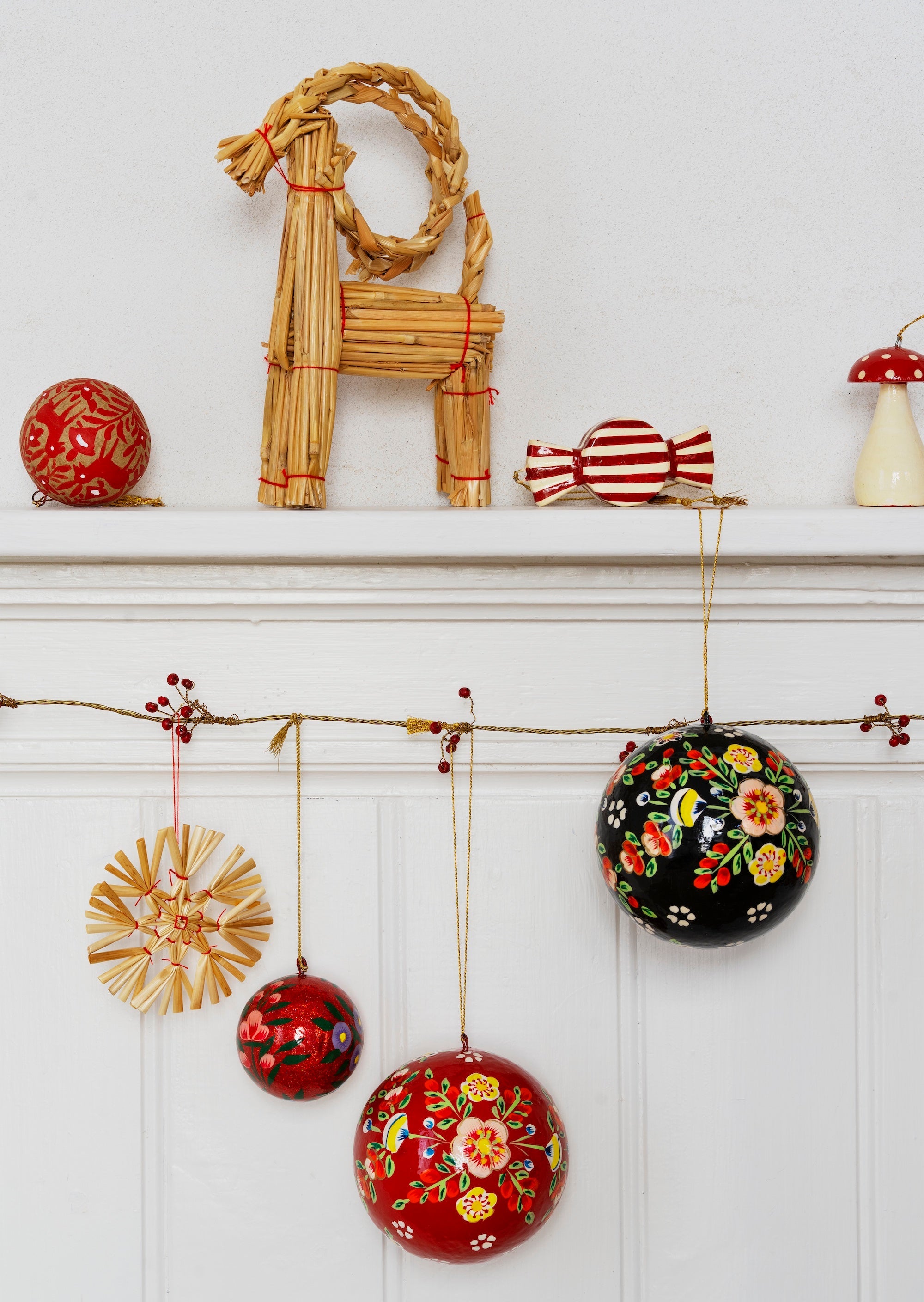 close up of traditional handmade christmas decorations with red and off white stripes
