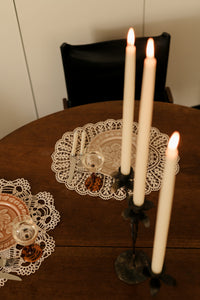 Lit Bellora candelabra by Olsson & Jensen on a round wooden table