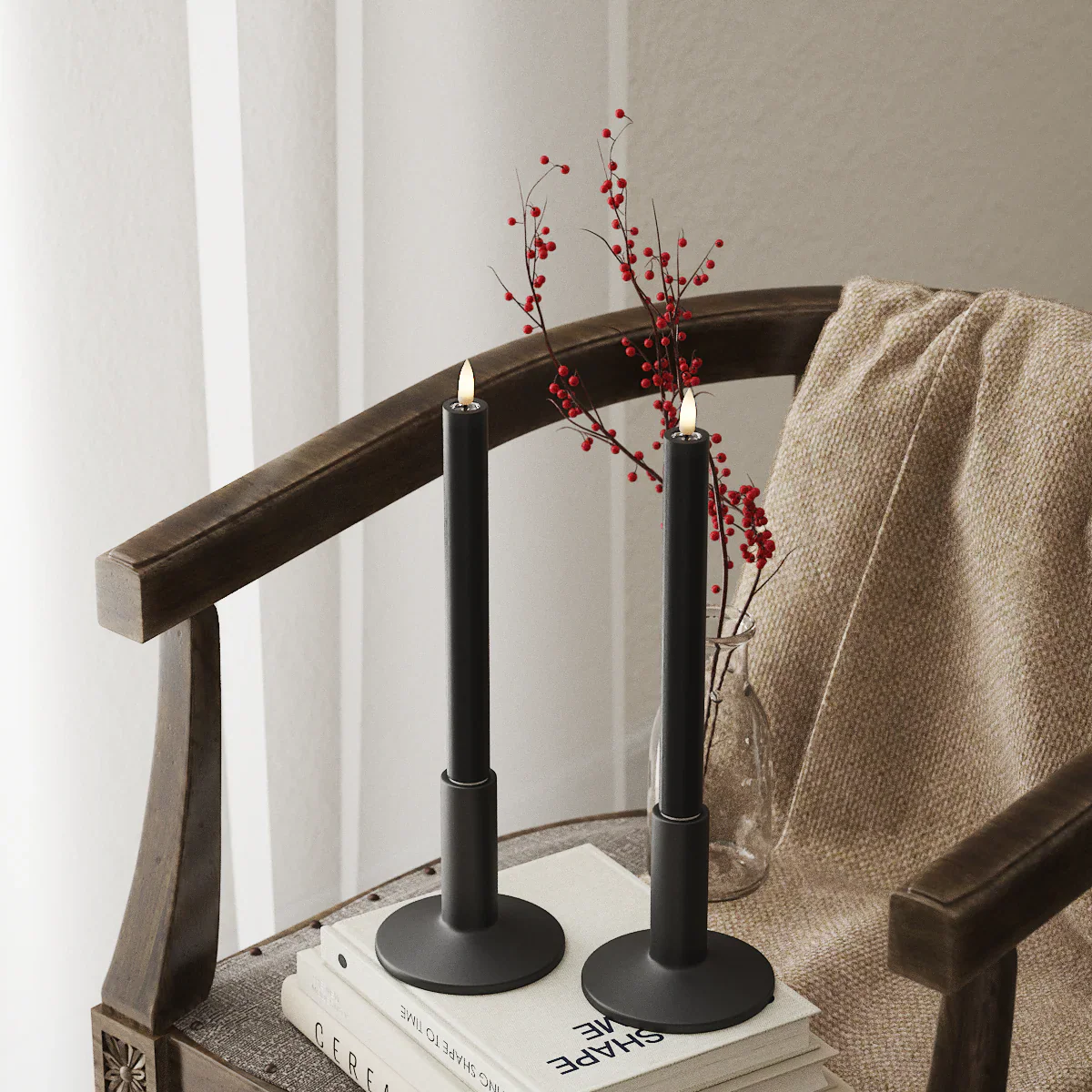 Black LED dinner candles glowing softly in a cosy winter interior