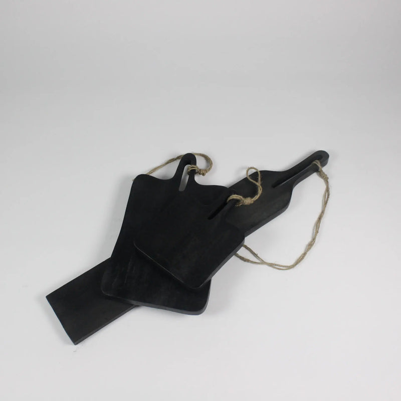 Three black mango wood serving boards by Olsson & Jensen in medium, large and long sizes