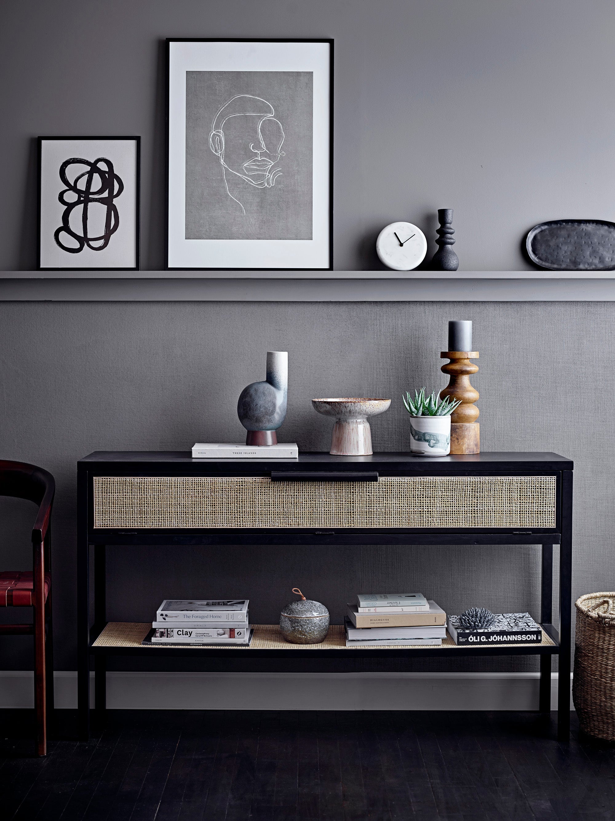 black stoneware candle holder styled on modern grey console with Nordic decor