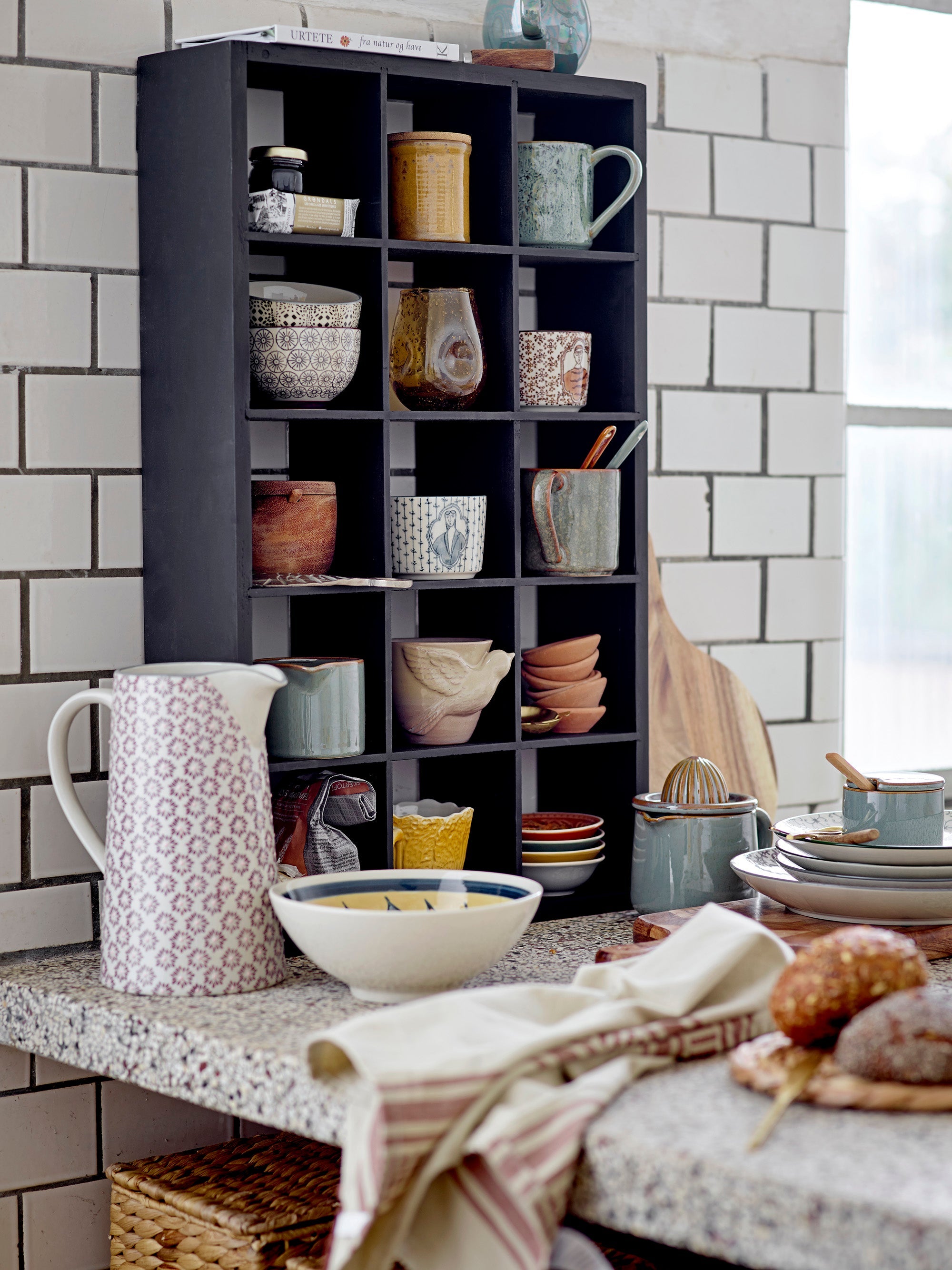 ustic kitchen shelf with assorted ceramics and green bloomingville pixie lemon juicer