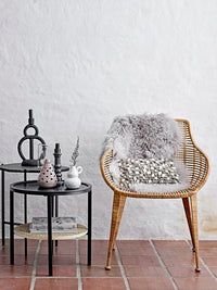 black sculptural ramina candle holder by bloomingville styled on side table in nordic living room
