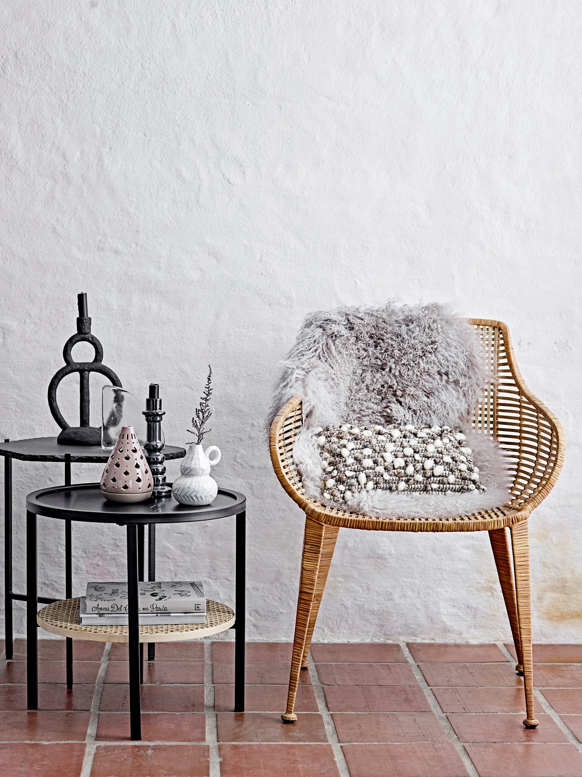 black sculptural ramina candle holder by bloomingville styled on side table in nordic living room
