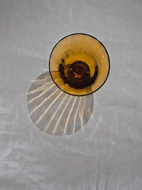 Boule amber glass by Olsson & Jensen seen from above on a linen cloth