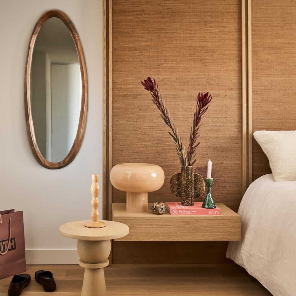 Urban Nature Culture pieces styled on a bedroom side table beside an oval mirror