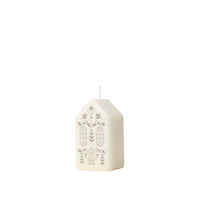 Side view of the white and silver Casa Figure Candle showing its gabled roof