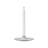 Nordic Sand Candle Holder with a white taper candle standing in the centre