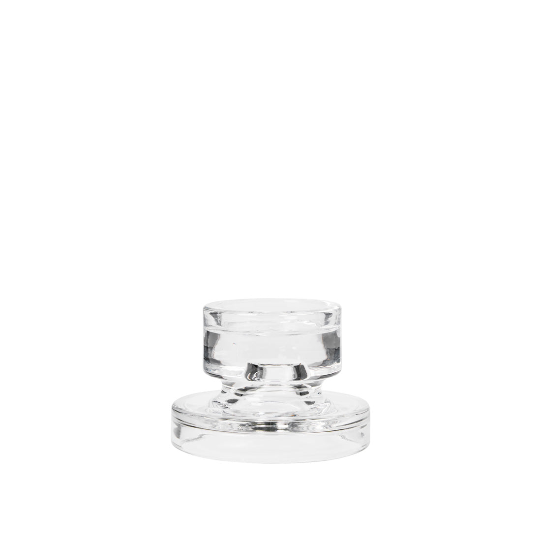 Petra clear glass candle holder from a raised angle, showing the stepped glass base