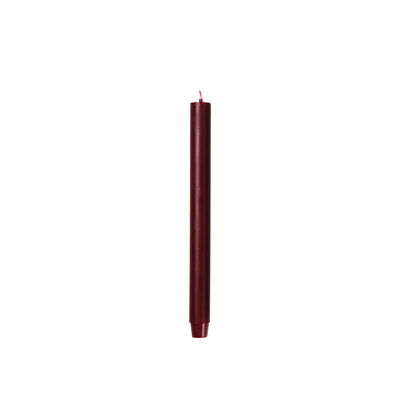 Broste Copenhagen Rustic Taper Candle in burgundy on a white background