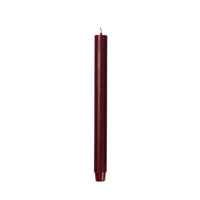 Burgundy Rustic Taper Candle standing upright, showing its mottled rustic surface