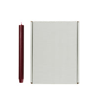 Burgundy Rustic Taper Candle shown beside its Broste Copenhagen grey box