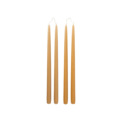 Four Broste Copenhagen Smooth Taper Candles in matt golden yellow on a white background