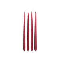 Four Broste Copenhagen Smooth Taper Candles in matt raspberry red on a white background