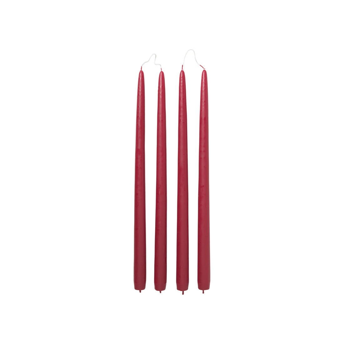 Four Broste Copenhagen Smooth Taper Candles in matt raspberry red on a white background