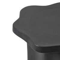Close-up of the Sonja Pedestal Low showing its matt black glaze and curved outline