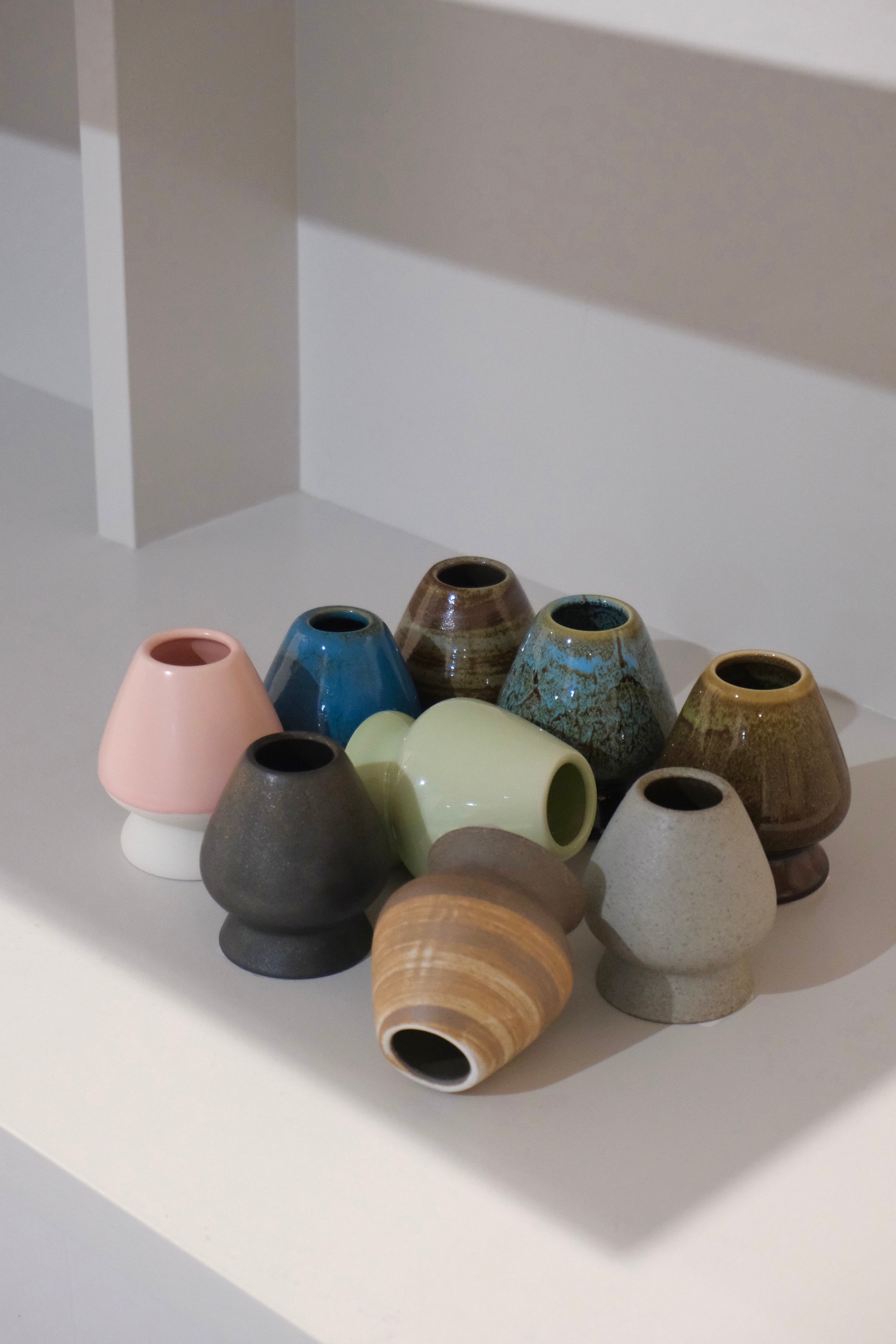 collection of ceramic chasen naoshi matcha whisk stands in multiple colours including blue
