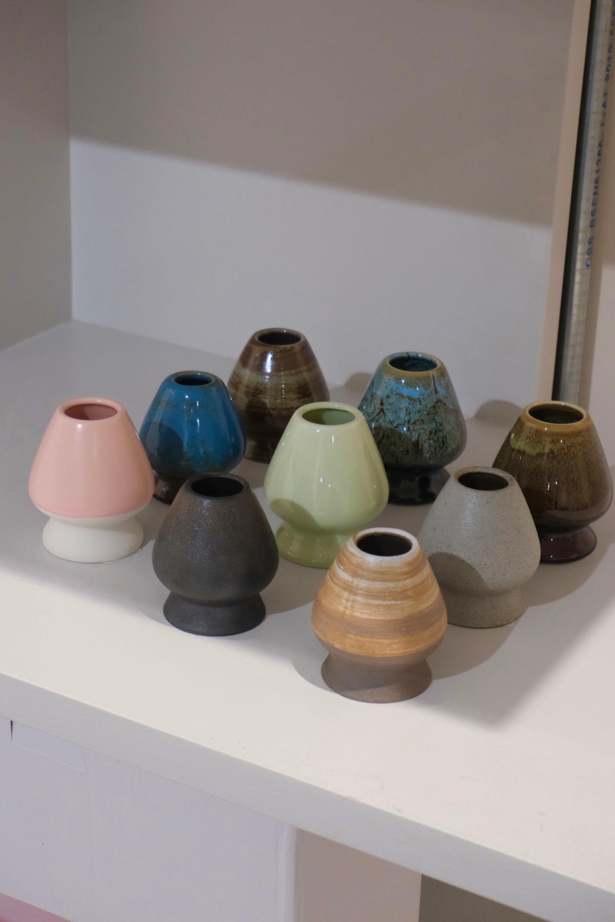 collection of ceramic chasen naoshi matcha whisk stands in multiple colours including eco green
