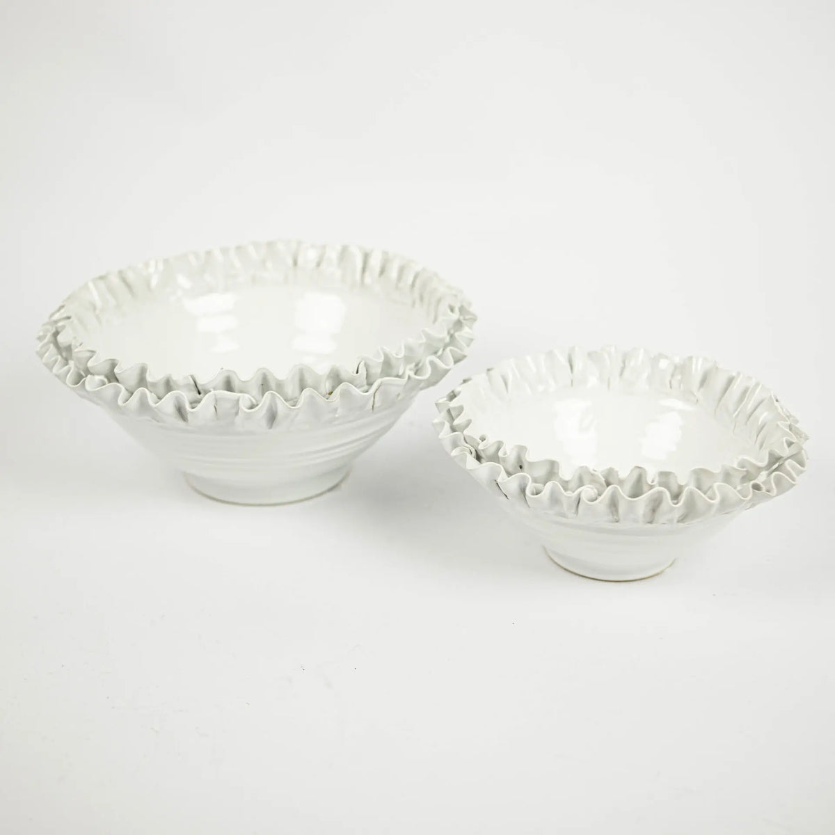 Two Claudine white ruffled edge ceramic bowls by Olsson & Jensen