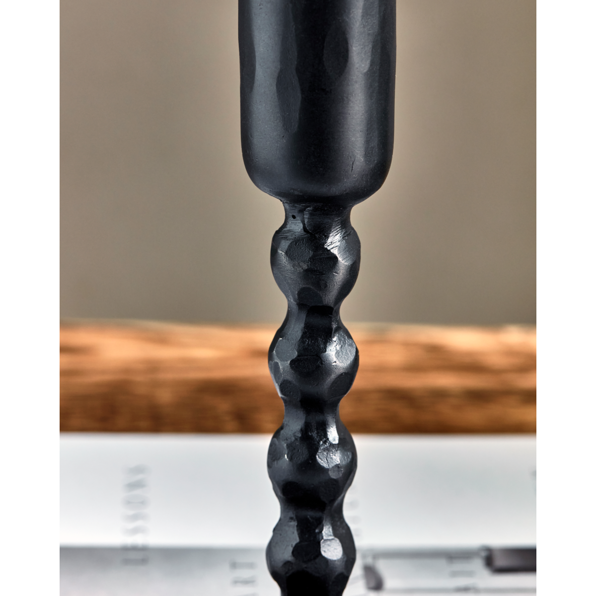 close up of handmade black candle holder with hammered finish
