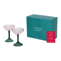 Two rose pink coupe glasses with the teal Cocktail Hour gift box and recipe card