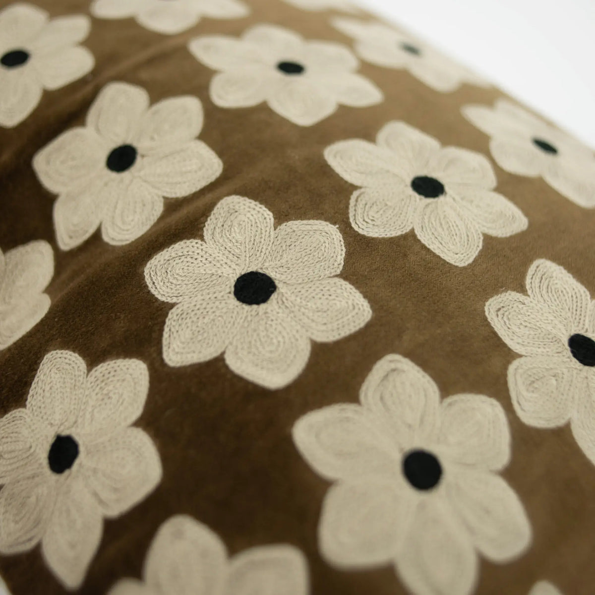 Close-up of the embroidered cream daisies on brown velvet, Daisy cushion by Olsson & Jensen