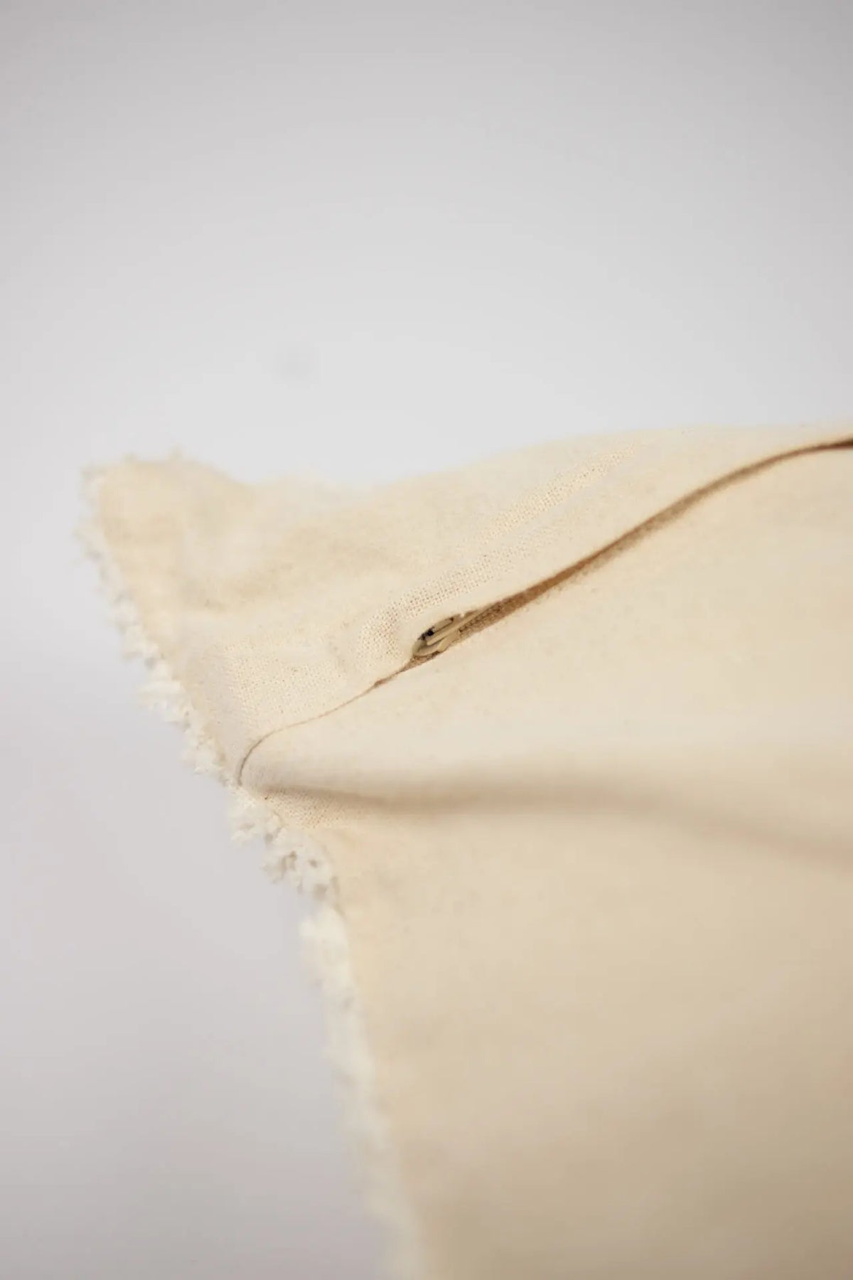 Edge detail of the Elba cream cushion by Olsson & Jensen showing the plain back