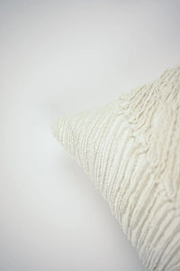 Corner detail of the Elba cream cushion by Olsson & Jensen showing the layered raw-edged cotton strips