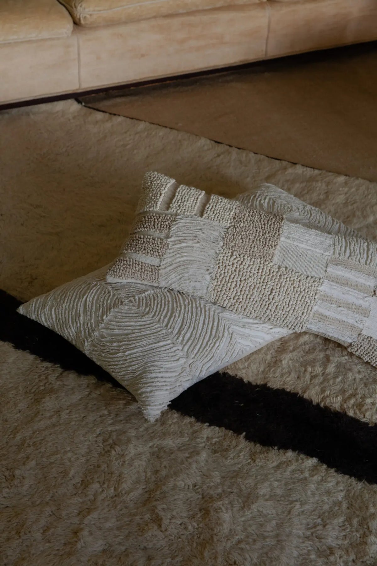 Elba cushion by Olsson & Jensen styled with other textured cushions on a wool rug