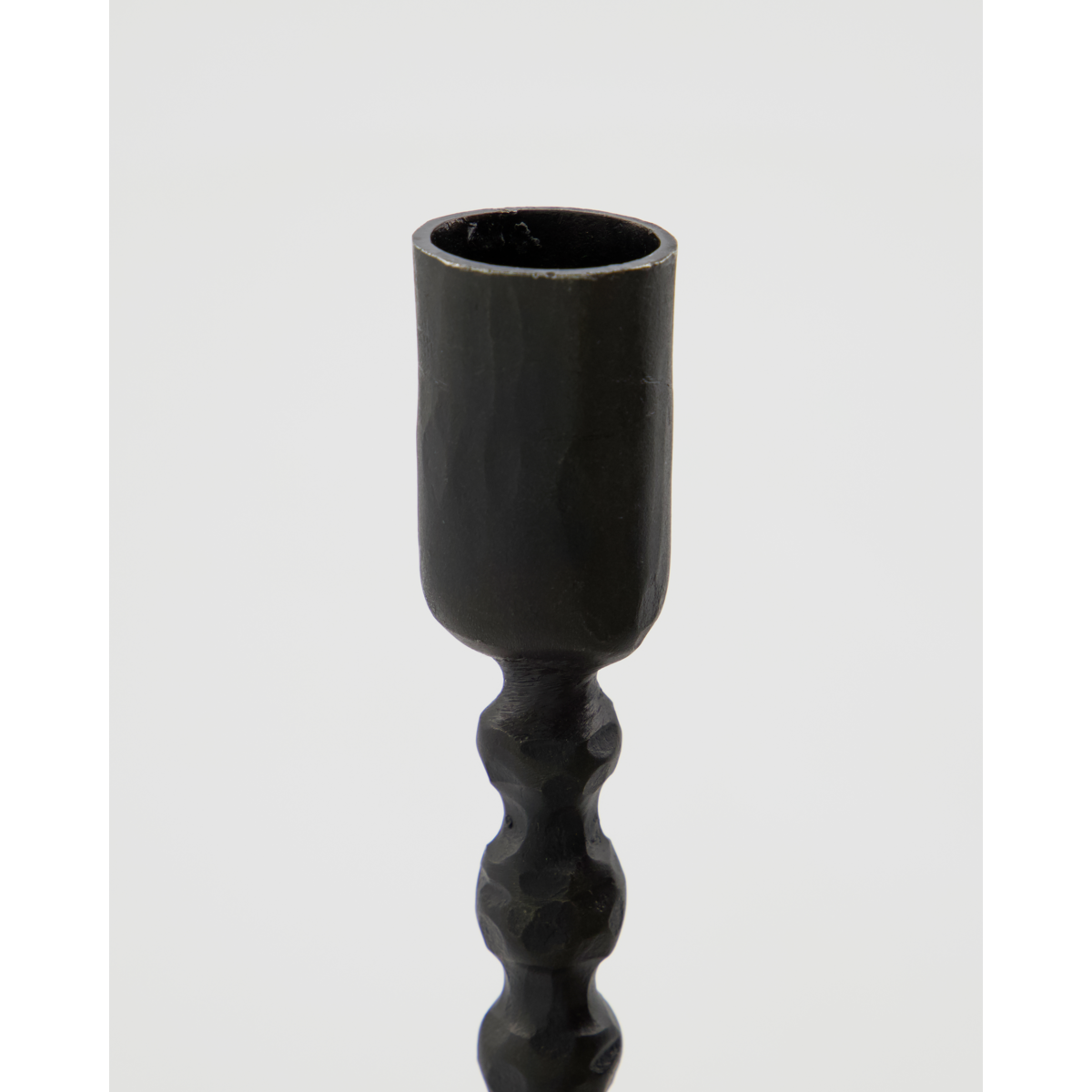 detail of ethnic-style handmade iron candlestick by house doctor
