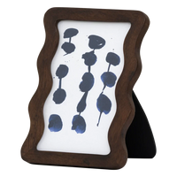 Side view of the Flette wavy mango wood photo frame standing upright