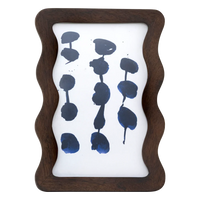 Flette wavy mango wood photo frame in walnut by Urban Nature Culture, front view with an abstract blue print