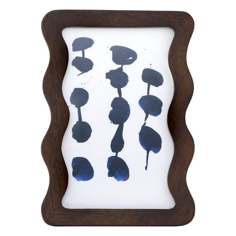 Flette wavy mango wood photo frame in walnut by Urban Nature Culture, front view with an abstract blue print