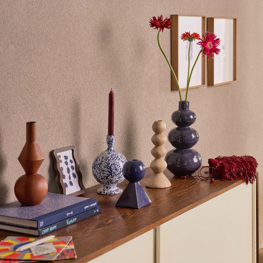 Flette wavy photo frame styled on a sideboard with sculptural vases, candles and books