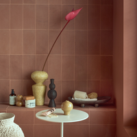 Urban Nature Culture ceramics styled on a terracotta tiled shelf and side table