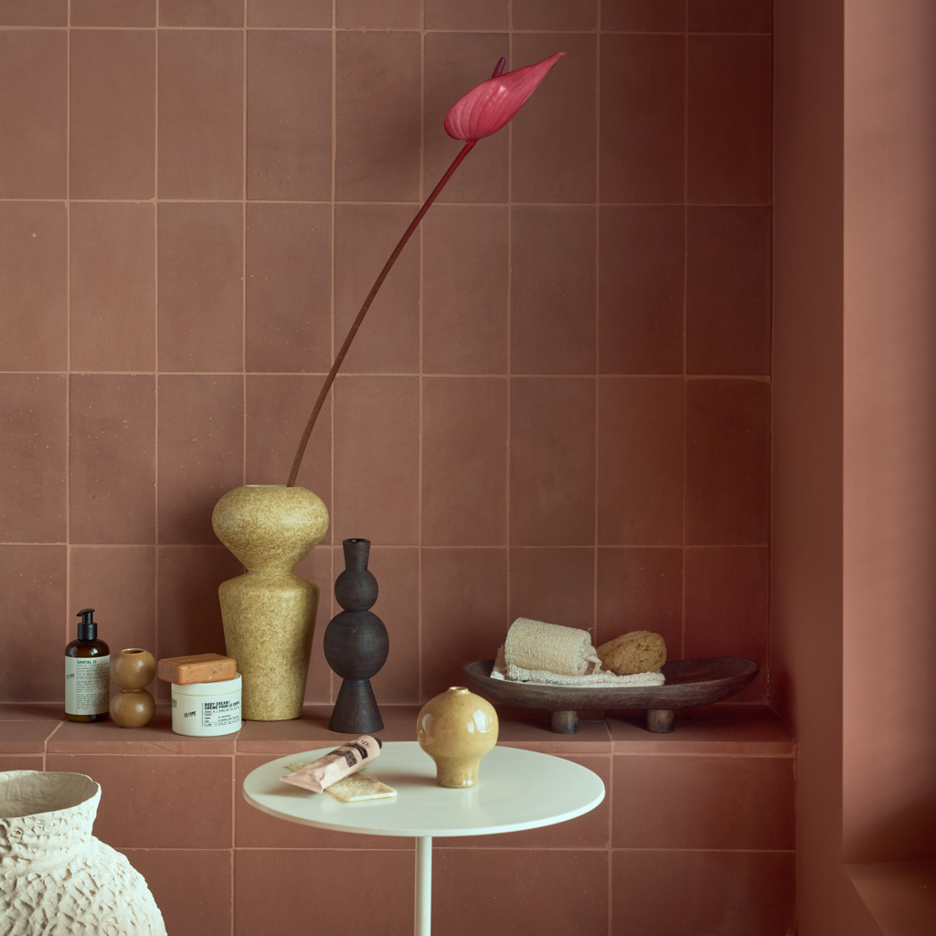 Urban Nature Culture ceramics styled on a terracotta tiled shelf and side table