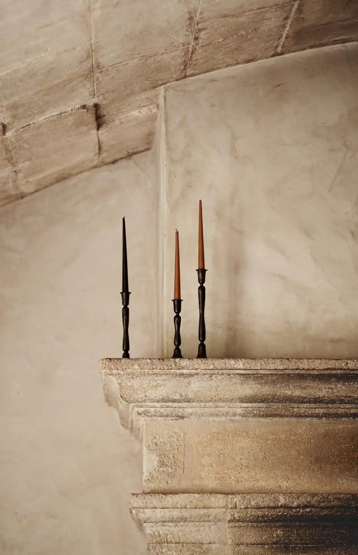Gill iron candlesticks by Olsson & Jensen styled on a stone ledge