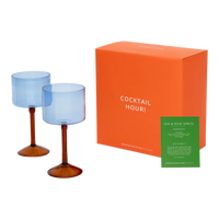 Two ice blue gin tonic glasses with the orange Cocktail Hour gift box and recipe card