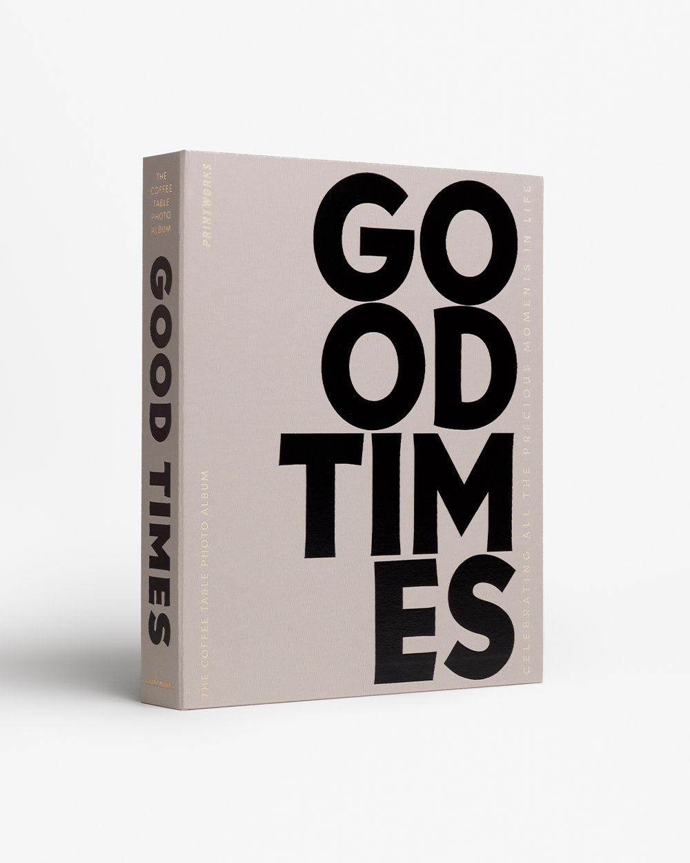 Good Times photo album styled on coffee table with books and flowers