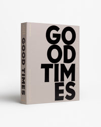 Good Times photo album styled on coffee table with books and flowers
