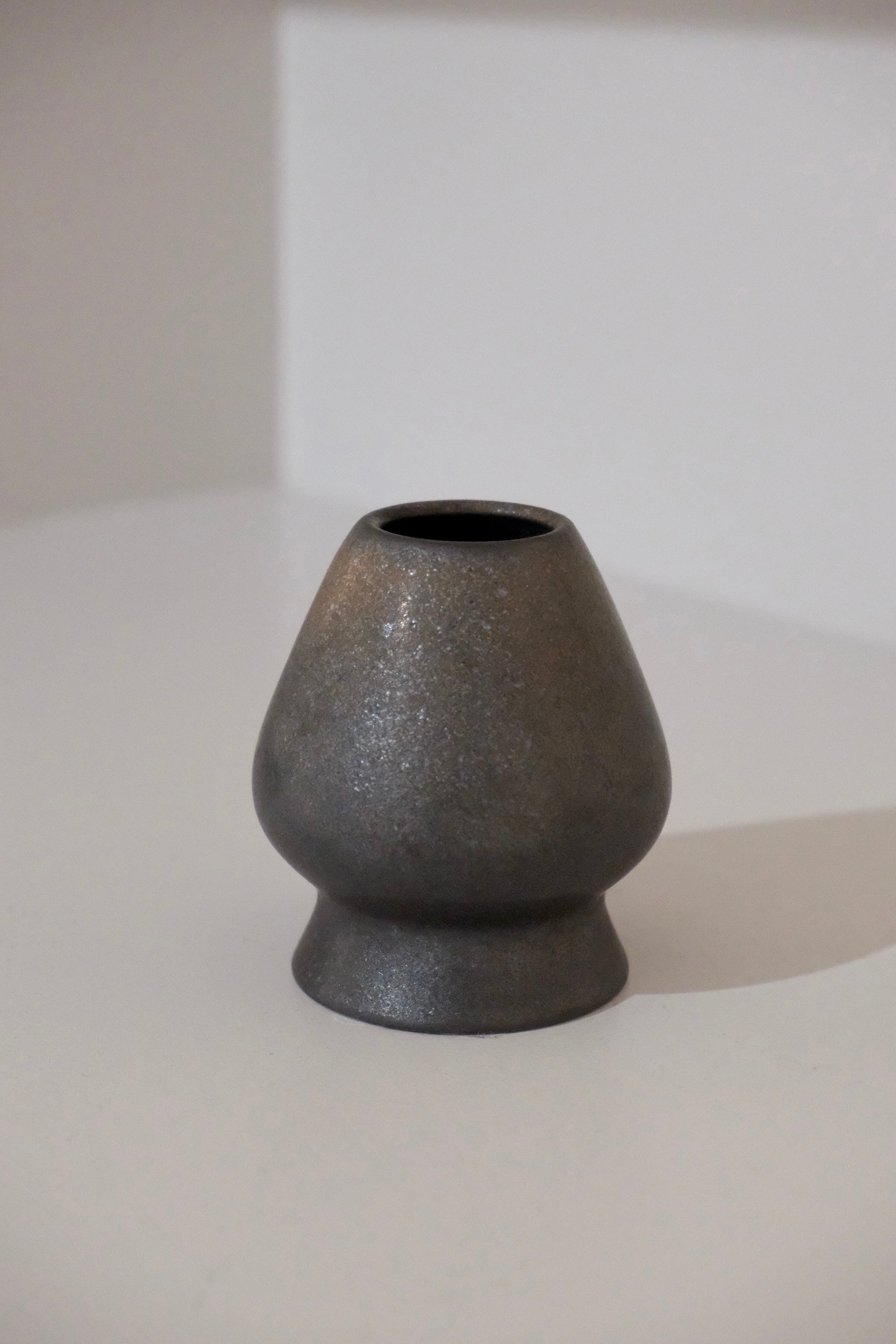 dark graphite chasen stand with pencil lead shimmer glaze angled view
