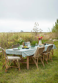 green drinking glass styled on outdoor checked tablecloth

