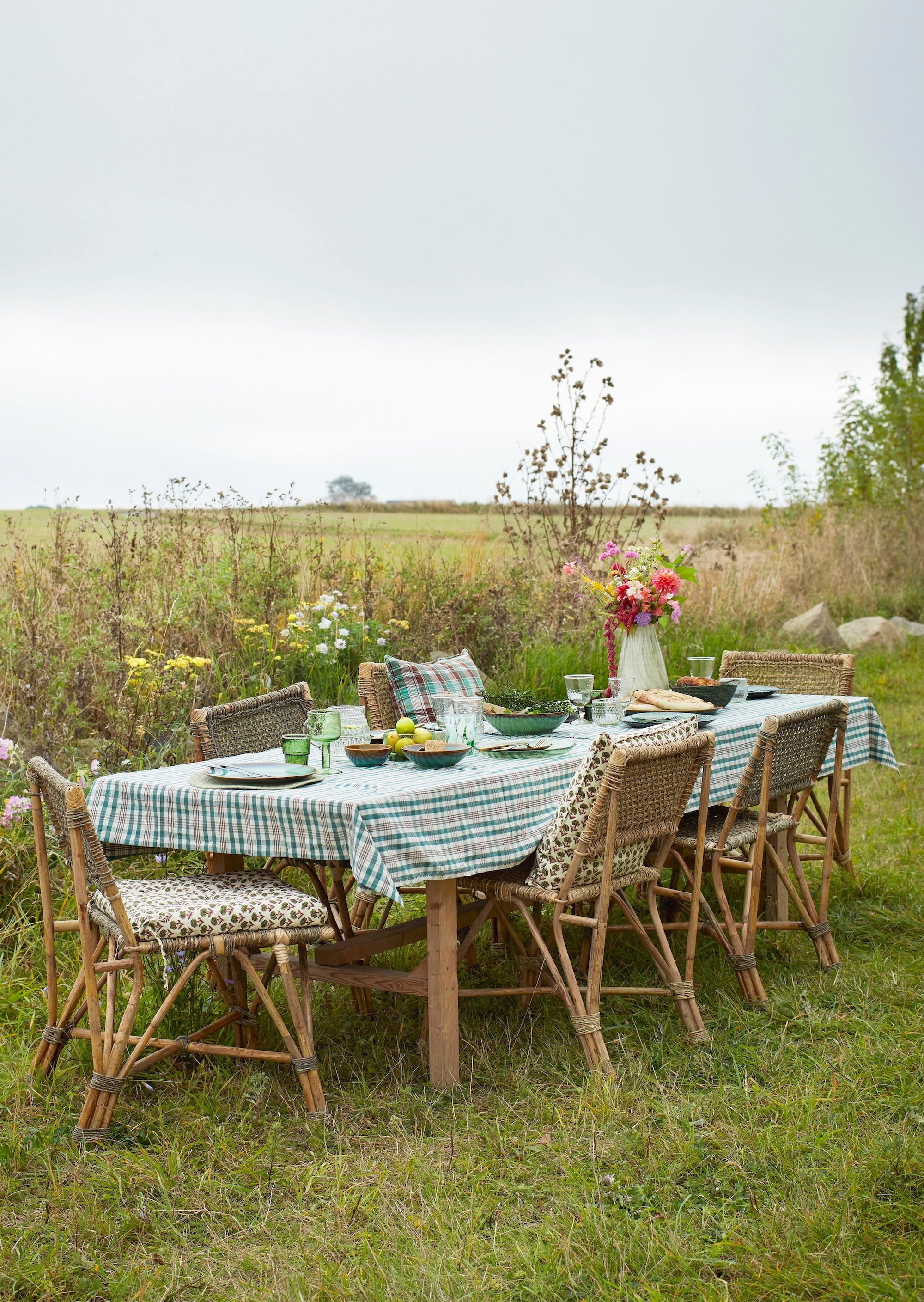 green drinking glass styled on outdoor checked tablecloth
