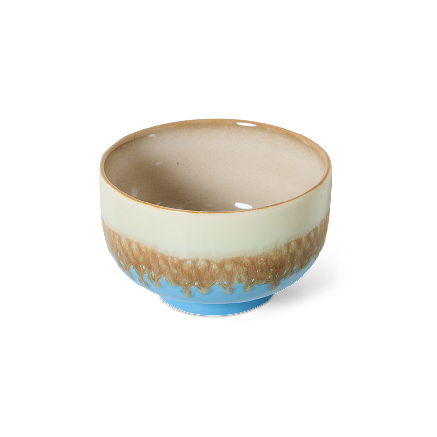 70s ceramics bowls and plates styled together in blue and earthy tones
