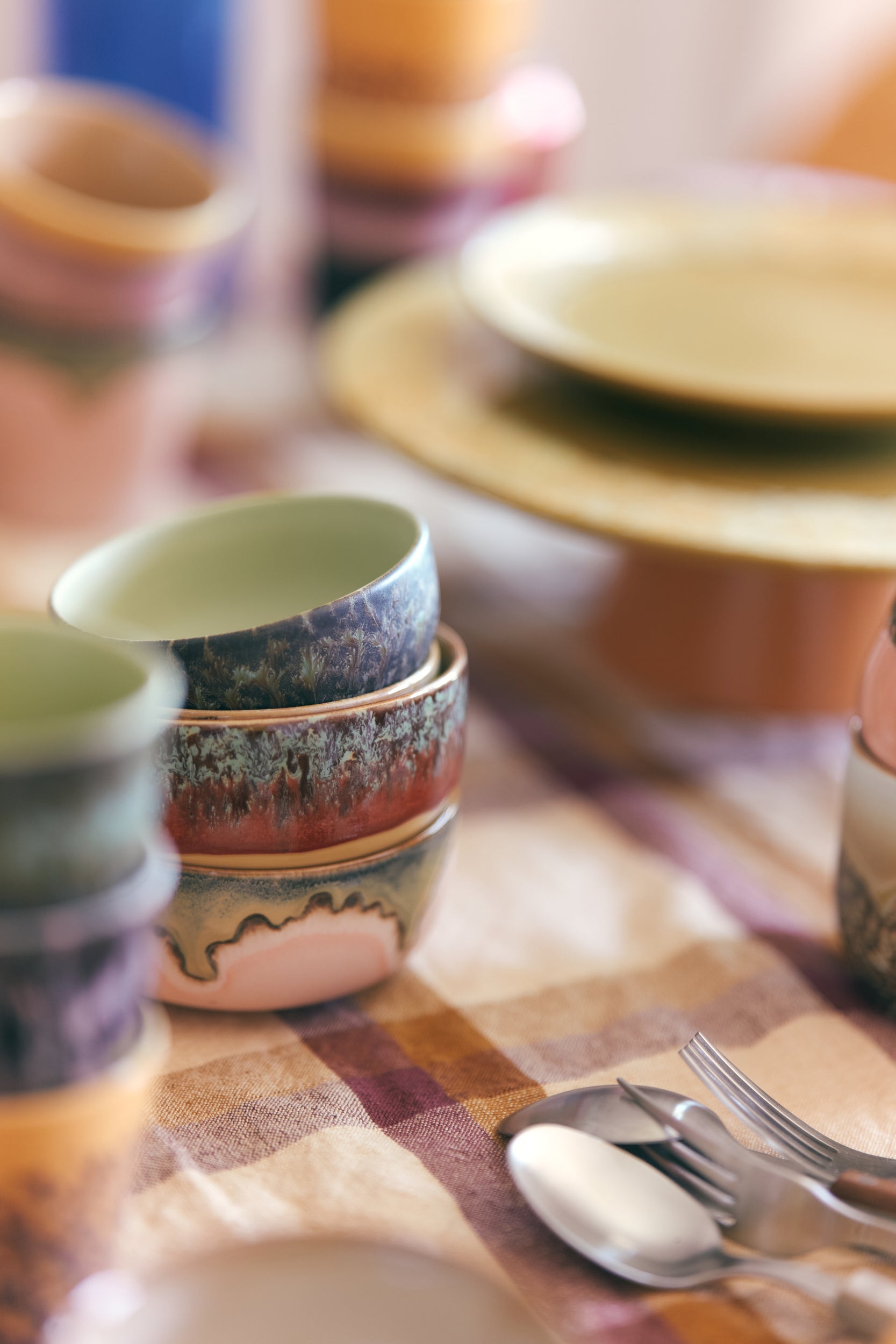 stacked HKLIVING 70s ceramics bowls styled on shelving with retro wallpaper
