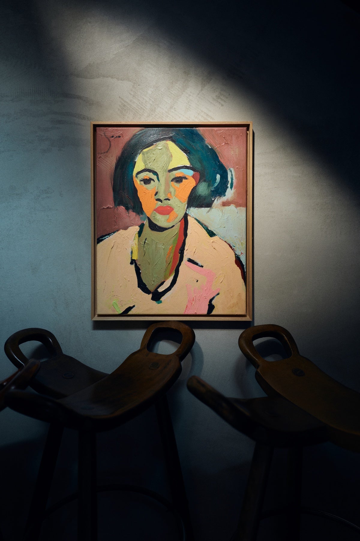 HKLIVING Self-Made portrait artwork hung on textured wall above dark wooden stools