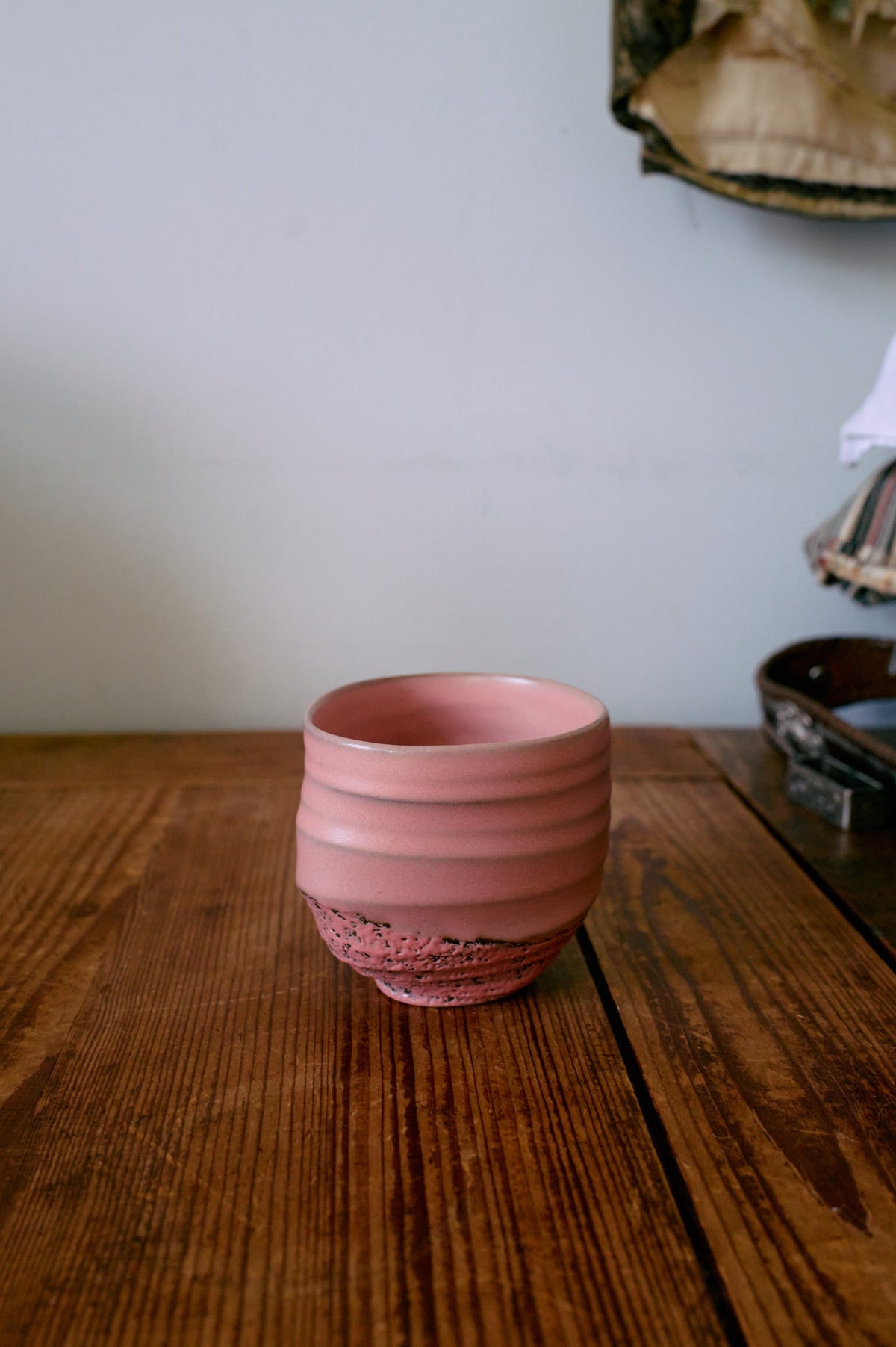 Pink hkliving smooth coffee cup with textured base bringing calm, tactile charm to a breakfast table.
