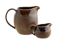 brown stoneware jugs in two sizes with reactive glaze and glossy rim
